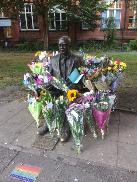 Alan Turing surrounded by a multiverse of models of arithmetic (= flowers)